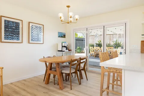 a view of a dining room with furniture wooden floor and chandelier