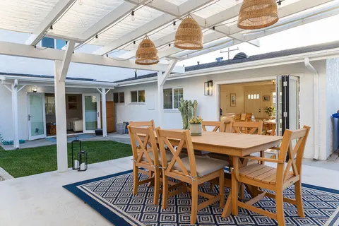 a view of a patio with a table and chairs