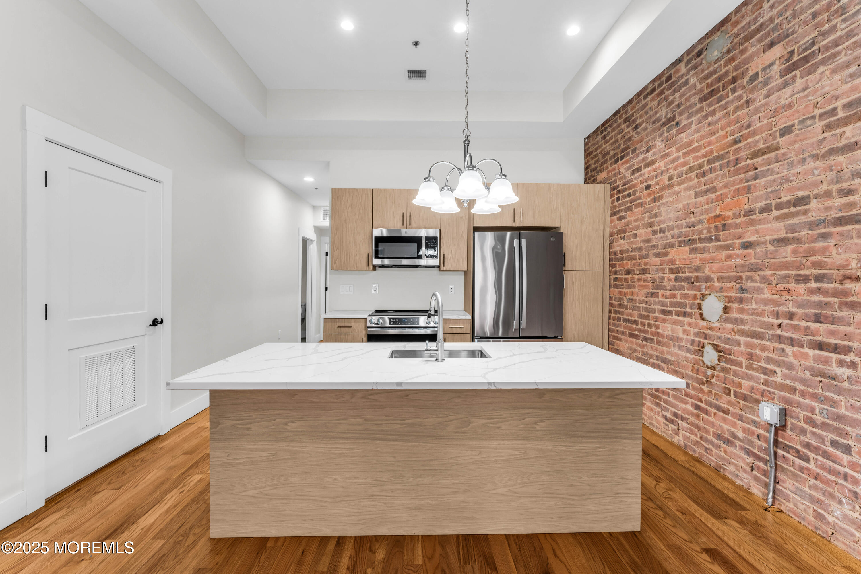 7 Broad Street, Unit 2 Red Bank, NJ 07701 - Photo 6 of 23 a room with a table chairs and a chandelier
