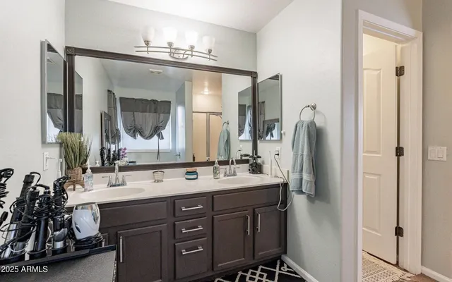a bathroom with a double vanity sink mirror and double