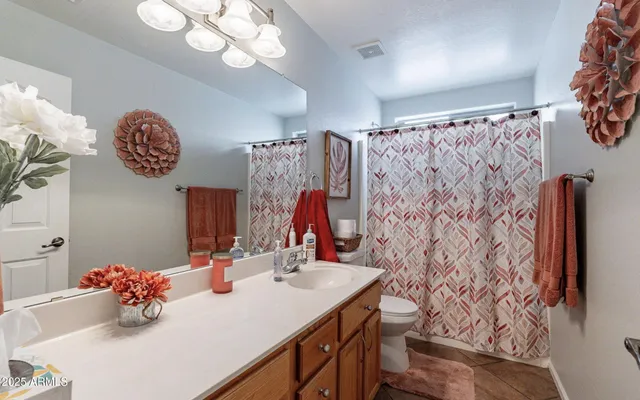 a bathroom with a sink a mirror and a shower curtain