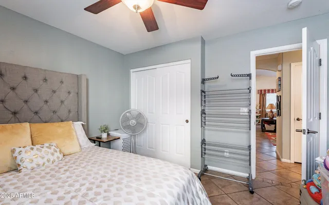 a bedroom with a bed and a painting on the wall