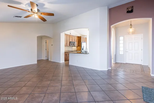 a view of a kitchen with a sink and a chandelier fan