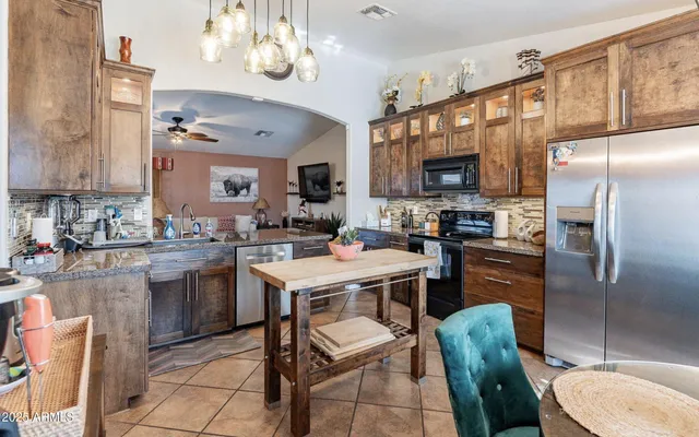 a kitchen with a sink stainless steel appliances and cabinets