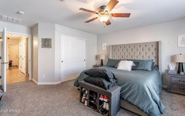 a bedroom with a bed and a chandelier
