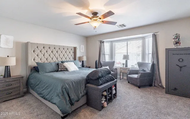 a bedroom with a bed and a large window