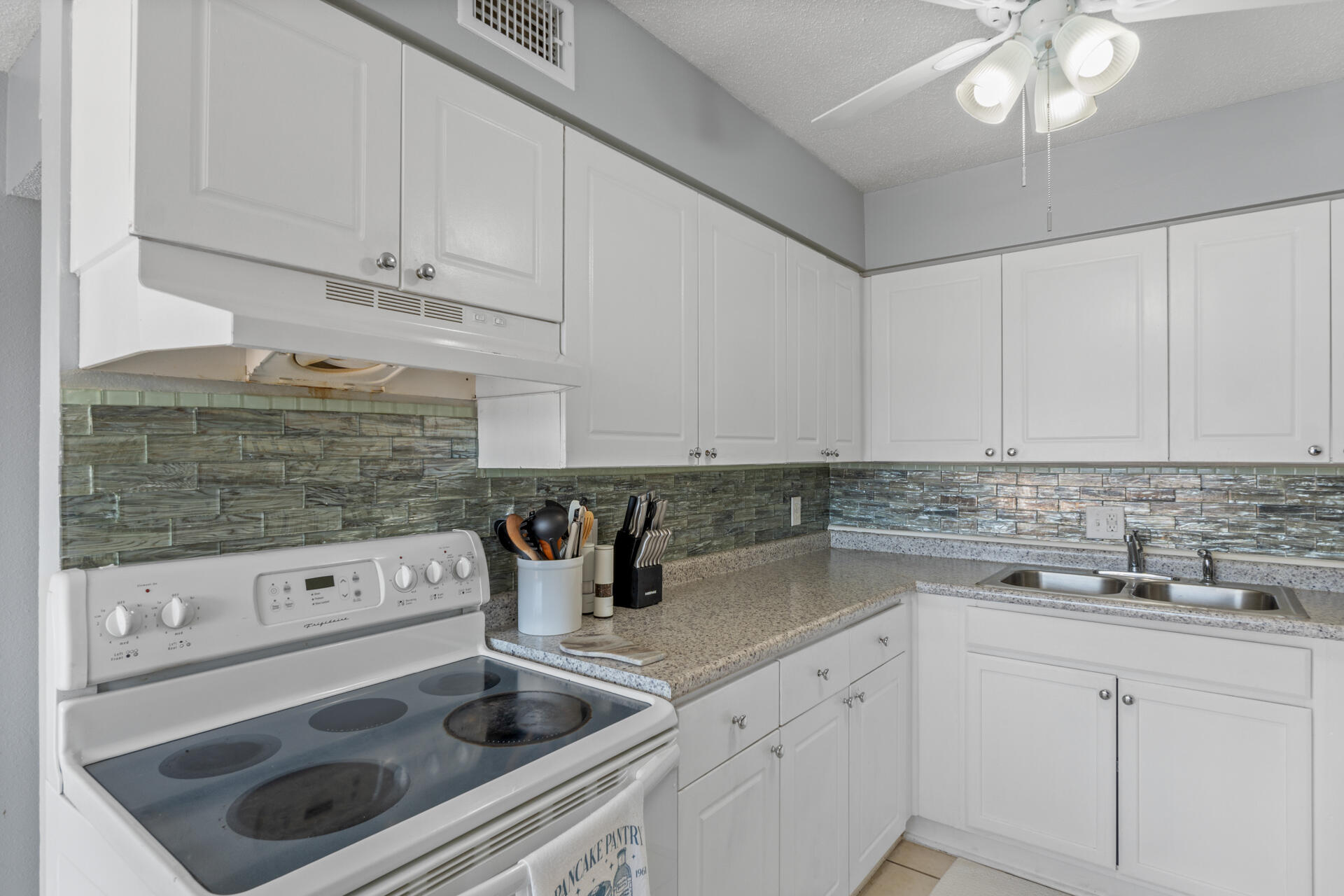 210 Pelham Road, Unit 220A Fort Walton Beach, FL 32547 - Photo 11 of 38 a kitchen with a sink dishwasher and cabinets