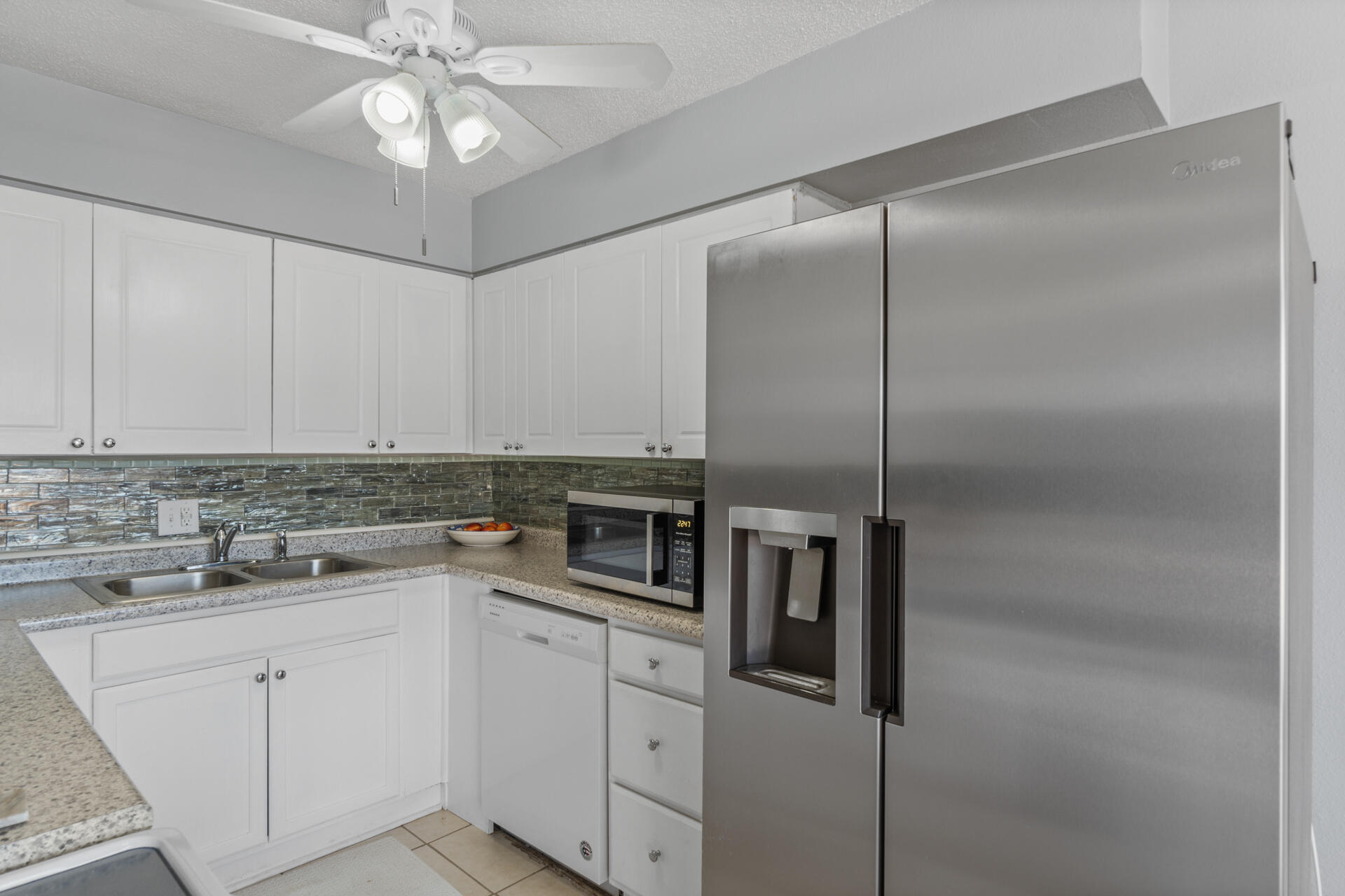 210 Pelham Road, Unit 220A Fort Walton Beach, FL 32547 - Photo 12 of 38 a kitchen with a refrigerator and a sink