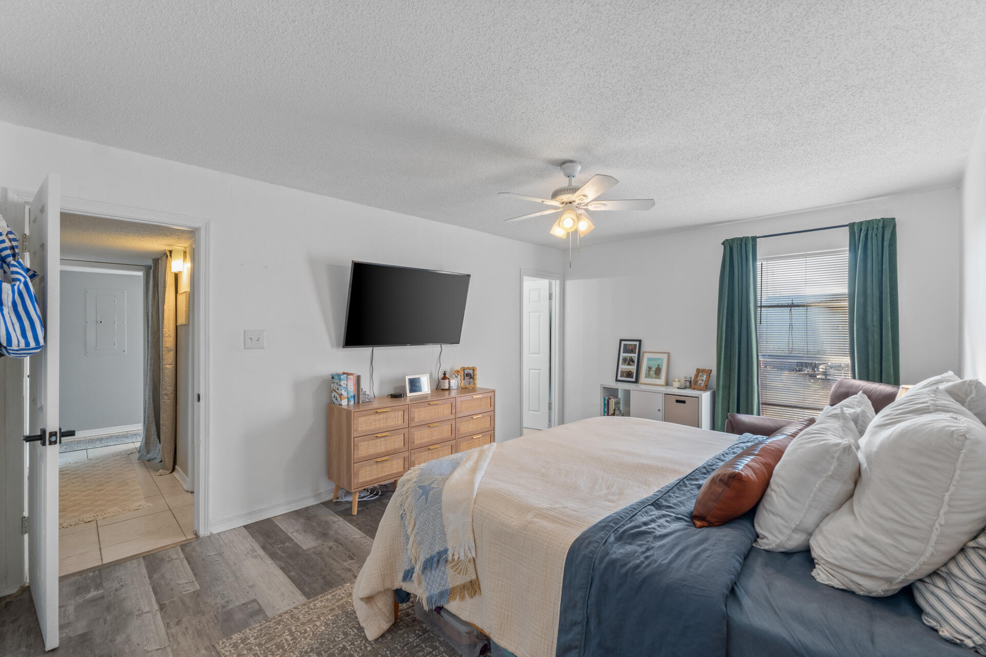 210 Pelham Road, Unit 220A Fort Walton Beach, FL 32547 - Photo 15 of 38 a bedroom with a bed and a flat screen tv