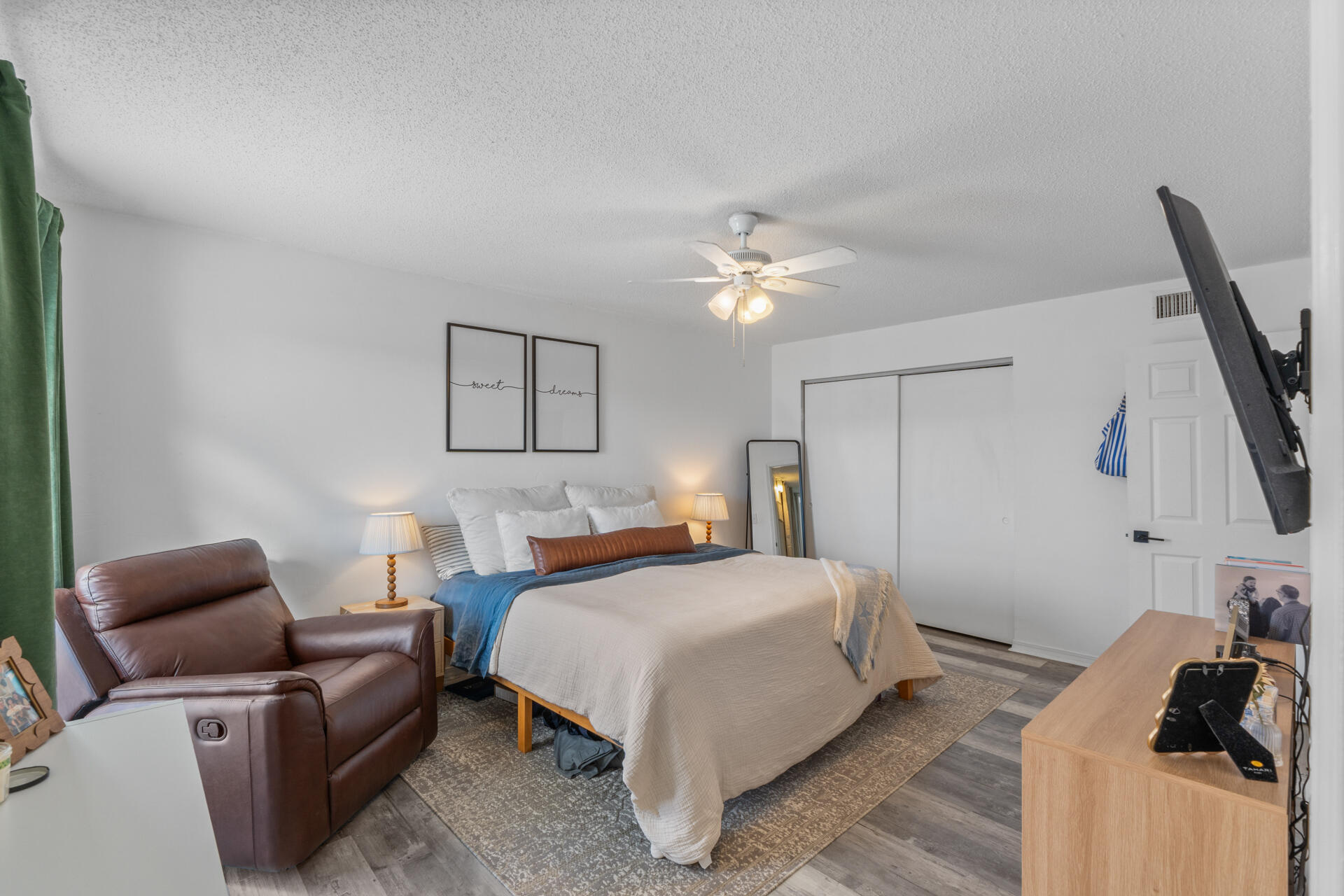210 Pelham Road, Unit 220A Fort Walton Beach, FL 32547 - Photo 17 of 38 a bedroom with a bed and a chandelier