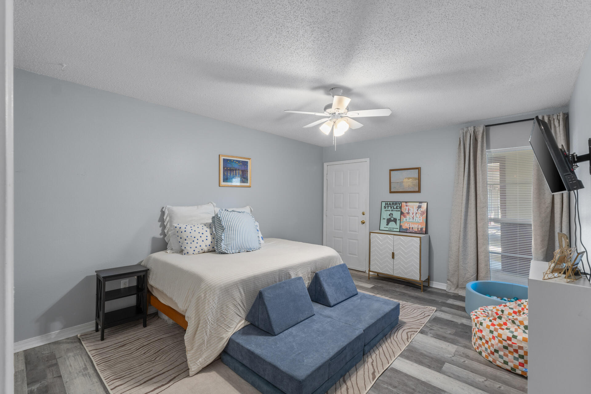 210 Pelham Road, Unit 220A Fort Walton Beach, FL 32547 - Photo 19 of 38 a bedroom with a bed and a chandelier