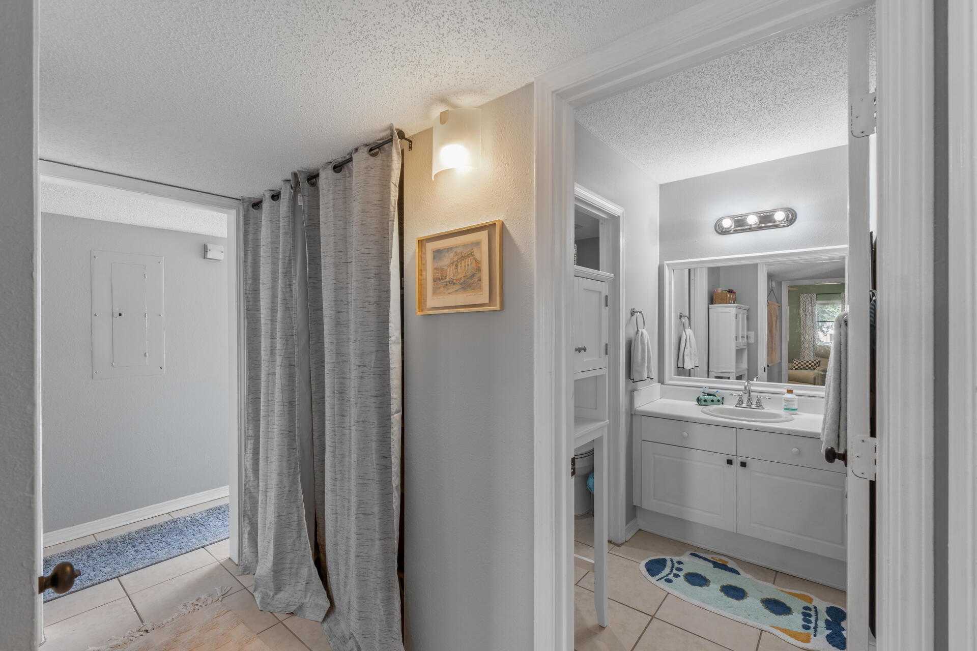 210 Pelham Road, Unit 220A Fort Walton Beach, FL 32547 - Photo 21 of 38 a bathroom with a mirror and a shower