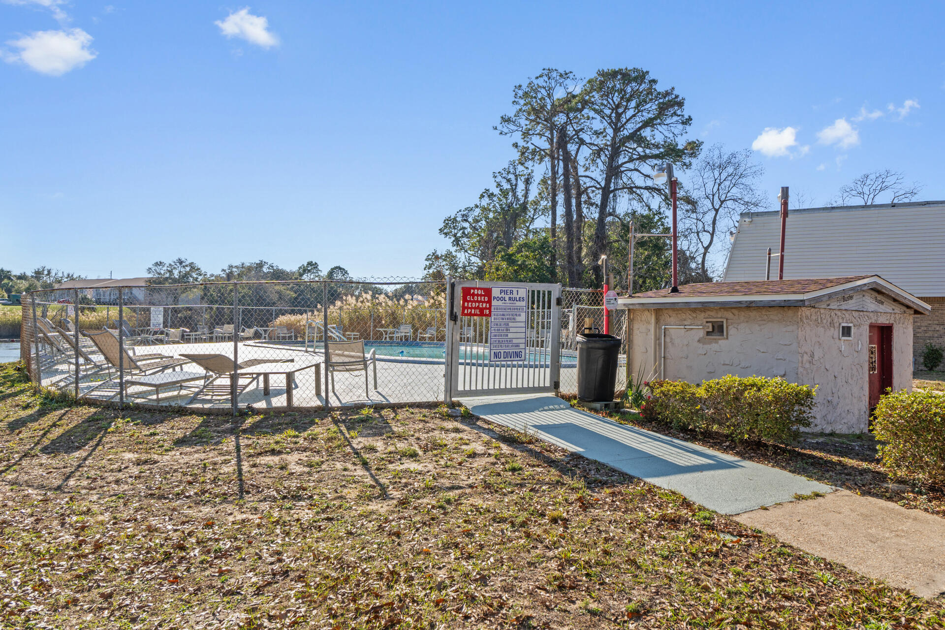 210 Pelham Road, Unit 220A Fort Walton Beach, FL 32547 - Photo 3 of 38 a view of a chairs and tables in the back yard of the house
