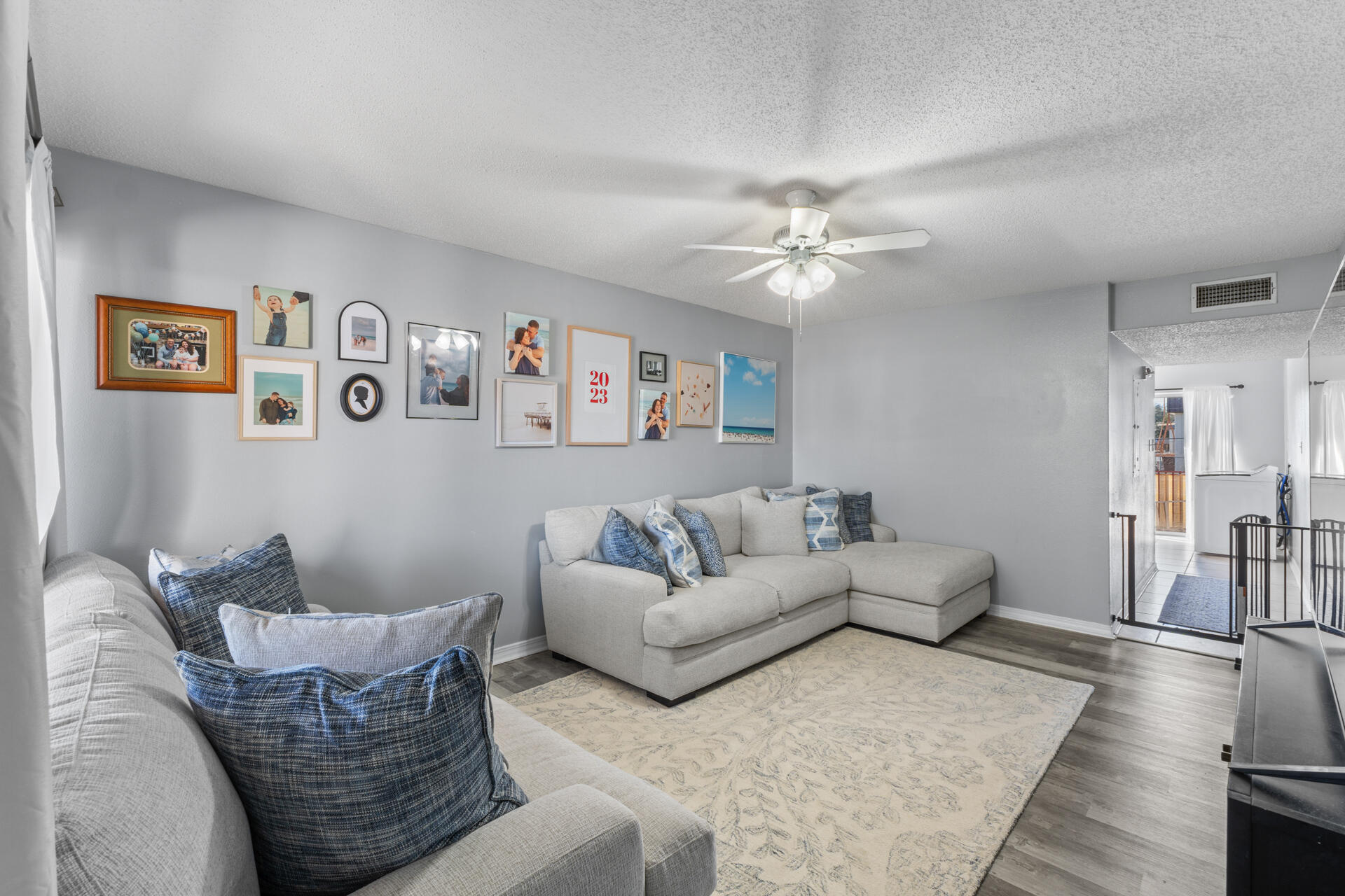 210 Pelham Road, Unit 220A Fort Walton Beach, FL 32547 - Photo 8 of 38 a living room with furniture and a chandelier