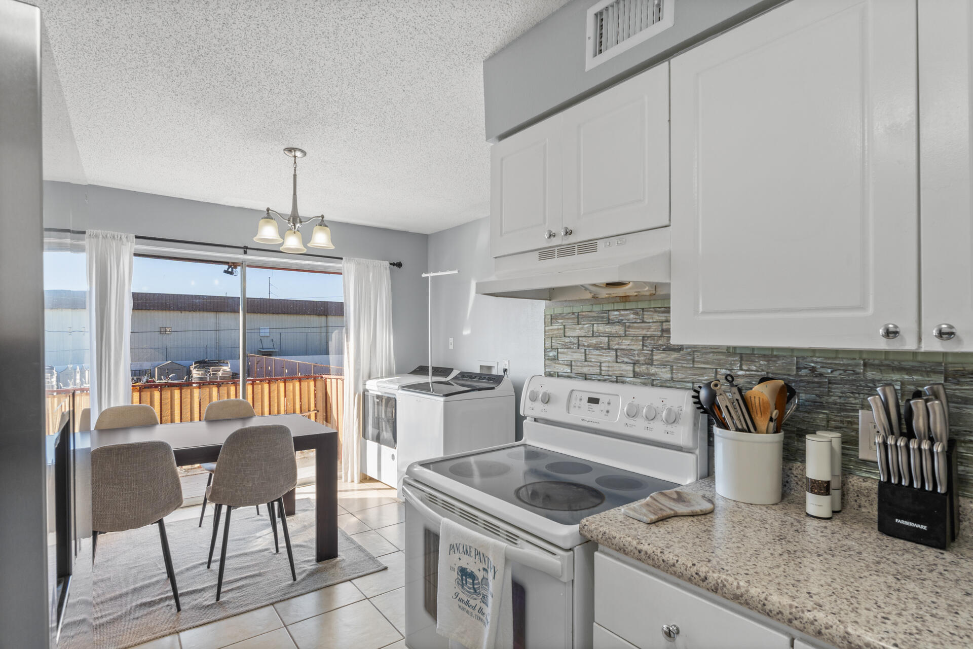 210 Pelham Road, Unit 220A Fort Walton Beach, FL 32547 - Photo 9 of 38 a kitchen with granite countertop a sink stove and cabinets