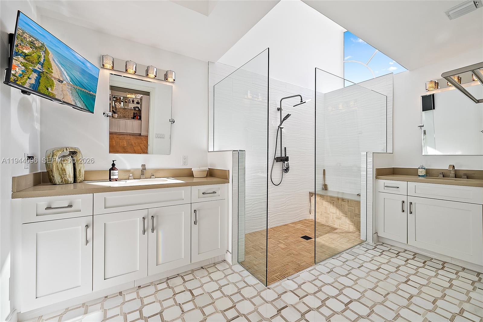 1602 Captains Way Jupiter, FL 33477 - Photo 12 of 35 a spacious bathroom with a granite countertop sink mirror and a