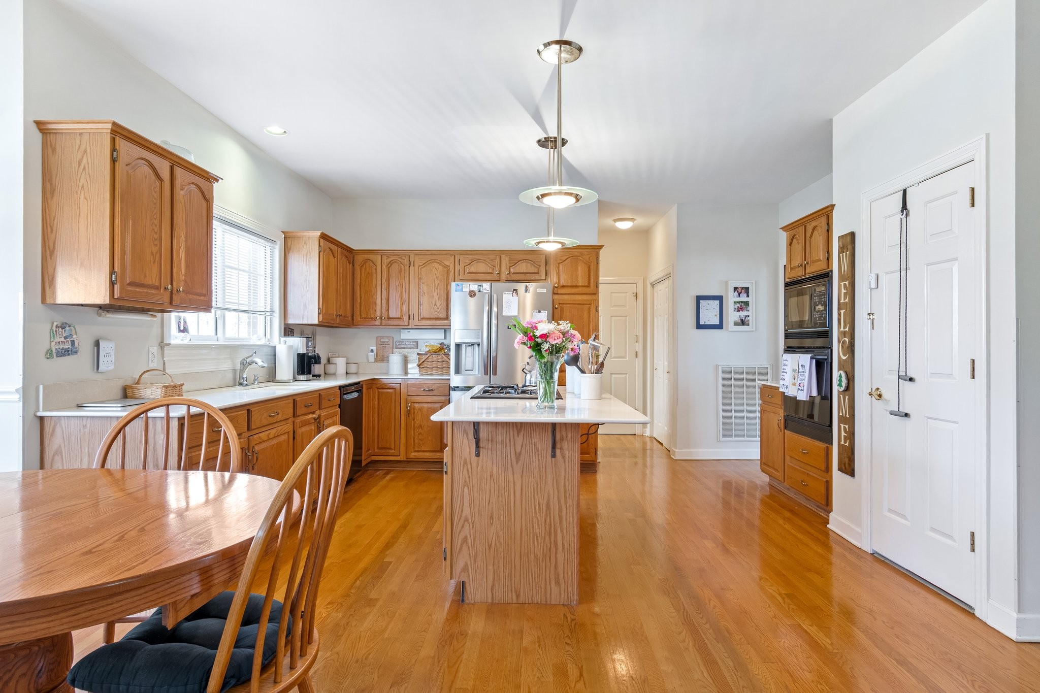 4259 Warren Road Franklin, TN 37067 - Photo 19 of 53 a view of a kitchen with kitchen island a large counter top space a sink stainless steel appliances and cabinets