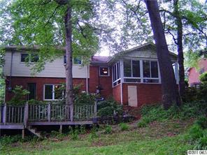 3922 Fellsway Road Charlotte, NC 28209 - Photo 2 of 16 a view of a brick house with a small yard plants and large trees