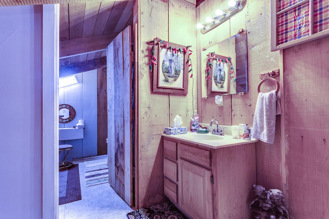4142 Wilhite Road Sevierville, TN 37876 - Photo 20 of 33 a bathroom with a sink vanity and a mirror