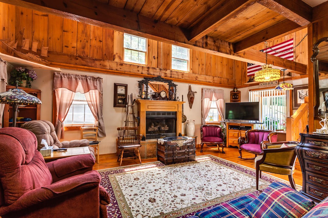 4142 Wilhite Road Sevierville, TN 37876 - Photo 3 of 33 a living room with furniture a flat screen tv and a fireplace