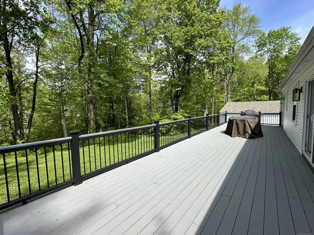 a view of balcony with wooden floor and fence