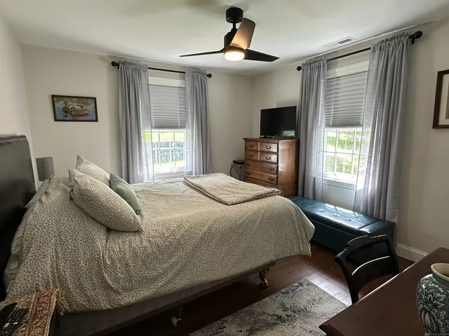 a bedroom with a bed and a flat screen tv