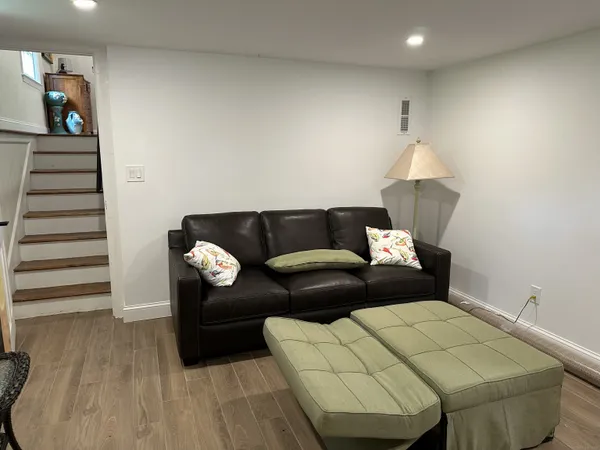 a living room with furniture and a wooden floor
