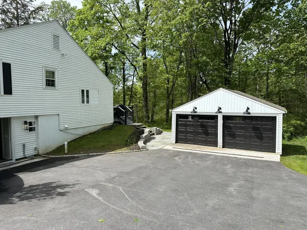 a view of a house with a yard and garage