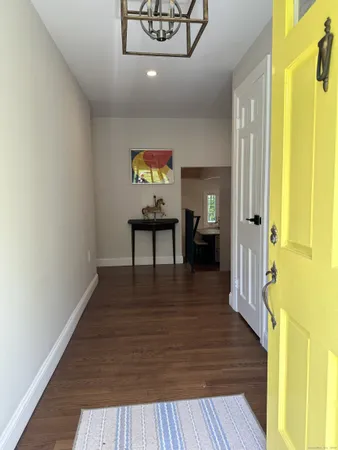 a view of a hallway view with wooden floor and staircase
