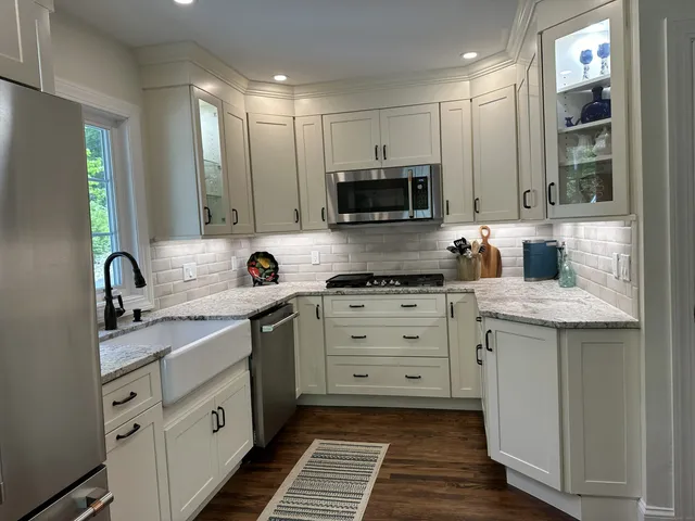 a kitchen with a sink stove and cabinets