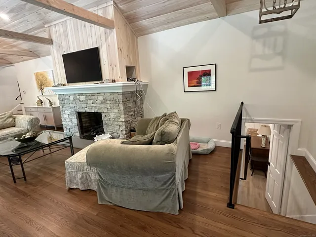 a living room with furniture fireplace and flat screen tv