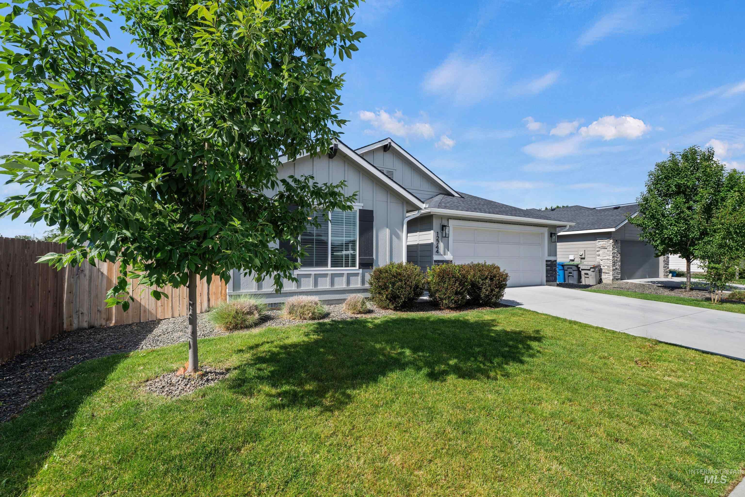 12744 West Fig Street Boise, ID 83713 - Photo 3 of 34 Contemporary single-story residence featuring light gray siding and a dark shingle roof