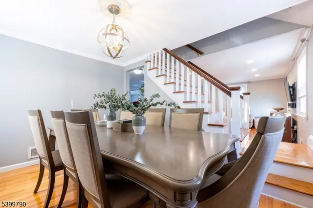 a dining room with furniture and wooden floor