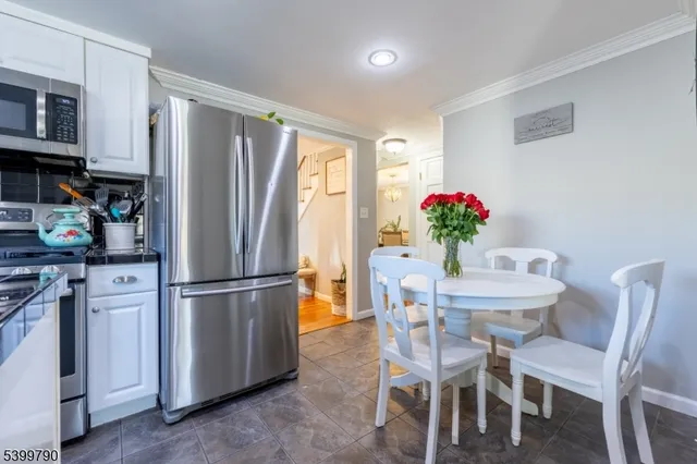 a kitchen with furniture and refrigerator