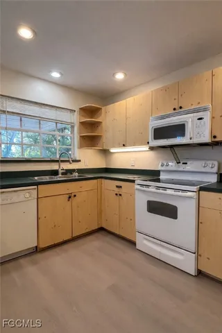 a white toilet sitting next to a bathroom sink