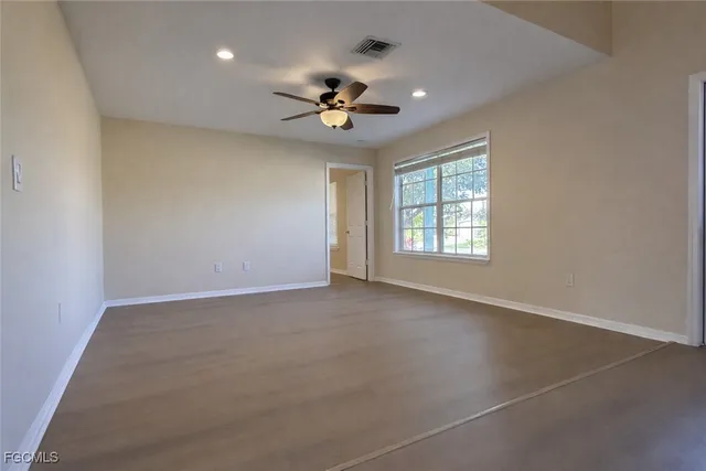 a view of a livingroom with a ceiling fan and window