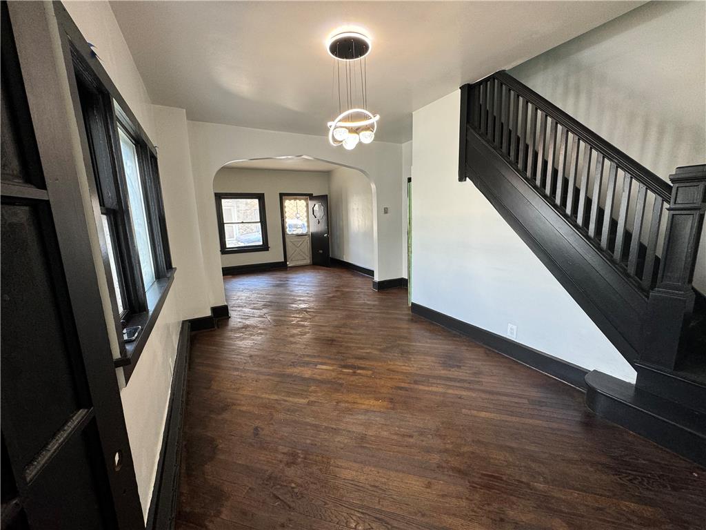 200 South Coal Street Shamokin, PA 17872 - Photo 2 of 18 Rich hardwood flooring complements the striking dark-painted trim and elegant staircase balustrade in this entryway.