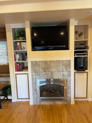 45 Chestnut Street Salinas, CA 93901 - Photo 13 of 23 a living room with a fireplace and a flat screen tv
