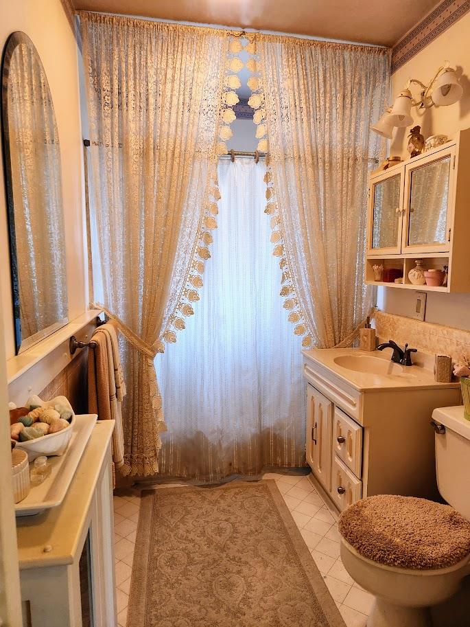 45 Chestnut Street Salinas, CA 93901 - Photo 20 of 23 a bathroom with a sink a toilet and shower curtain