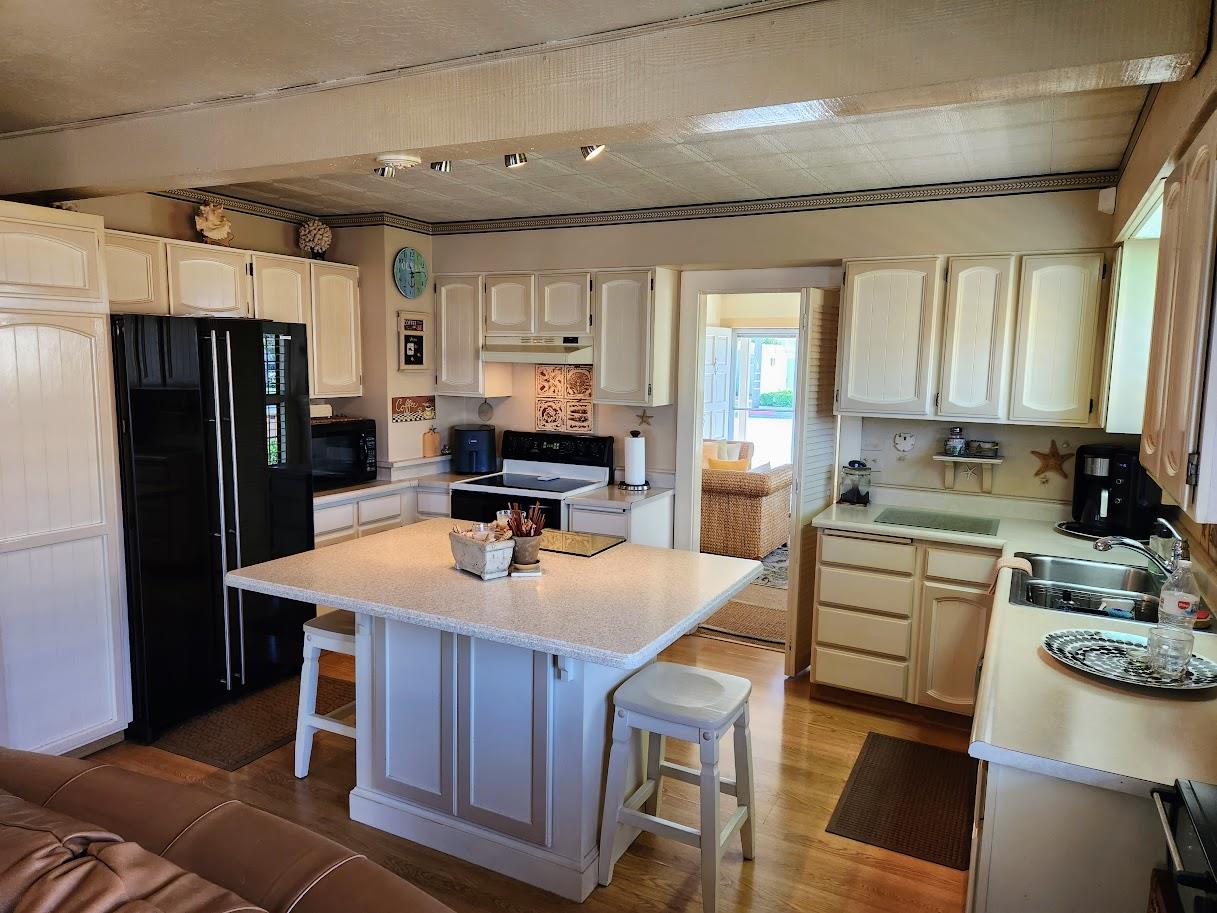 45 Chestnut Street Salinas, CA 93901 - Photo 4 of 23 a kitchen with kitchen island a stove a sink a refrigerator and a refrigerator