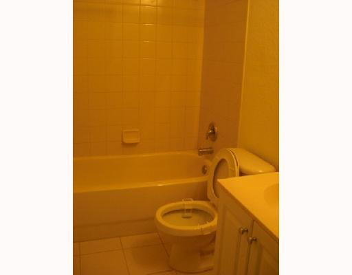 1920 Hibiscus Lane, Unit 163 Riviera Beach, FL 33404 - Photo 11 of 16 a bathroom with a granite countertop sink and a mirror