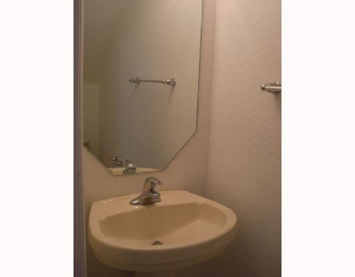 1920 Hibiscus Lane, Unit 163 Riviera Beach, FL 33404 - Photo 7 of 16 a bathroom with a sink and mirror