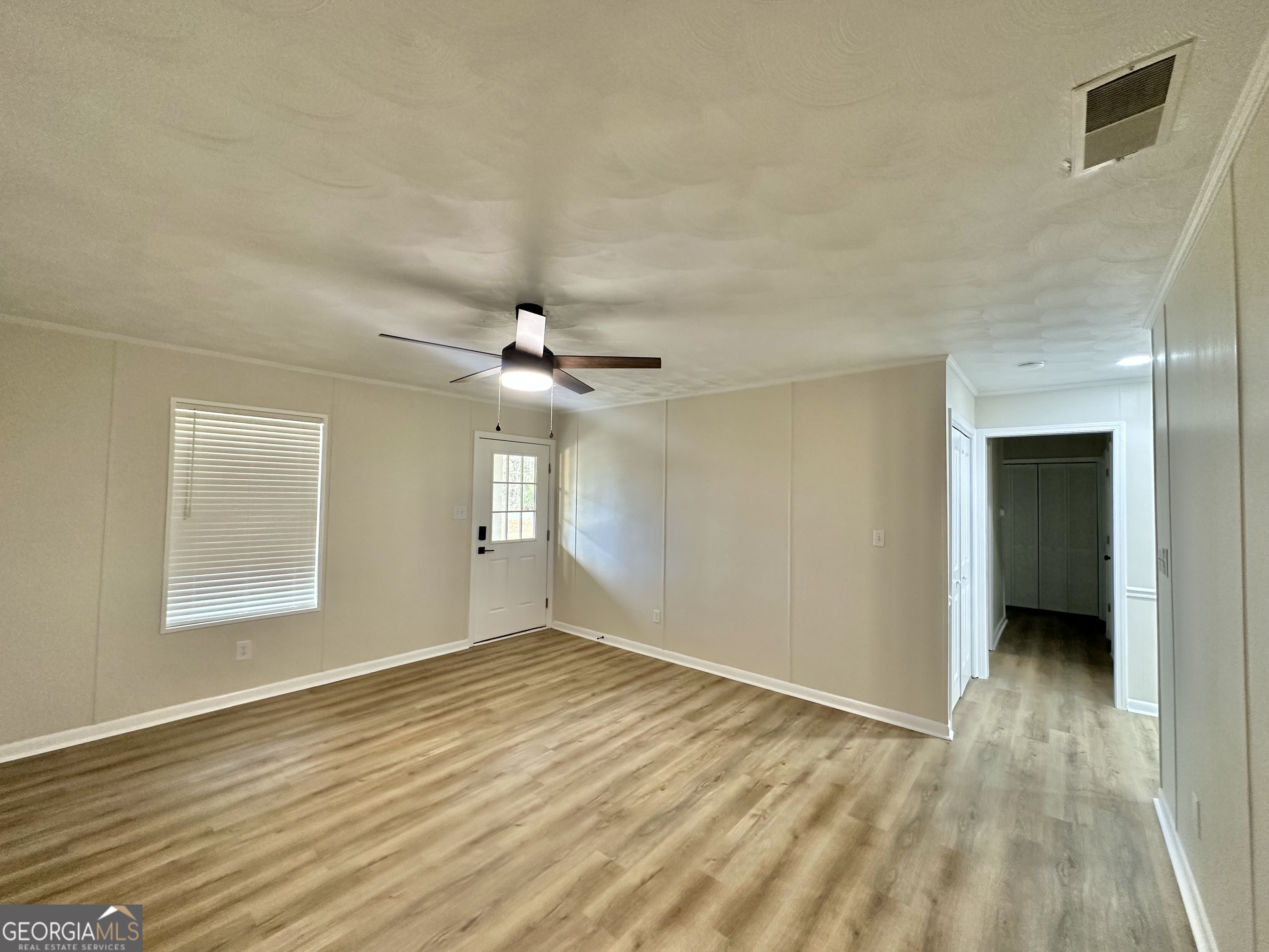 72 10th Street McRae-Helena, GA 31037 - Photo 14 of 26 wooden floor in an empty room with a window