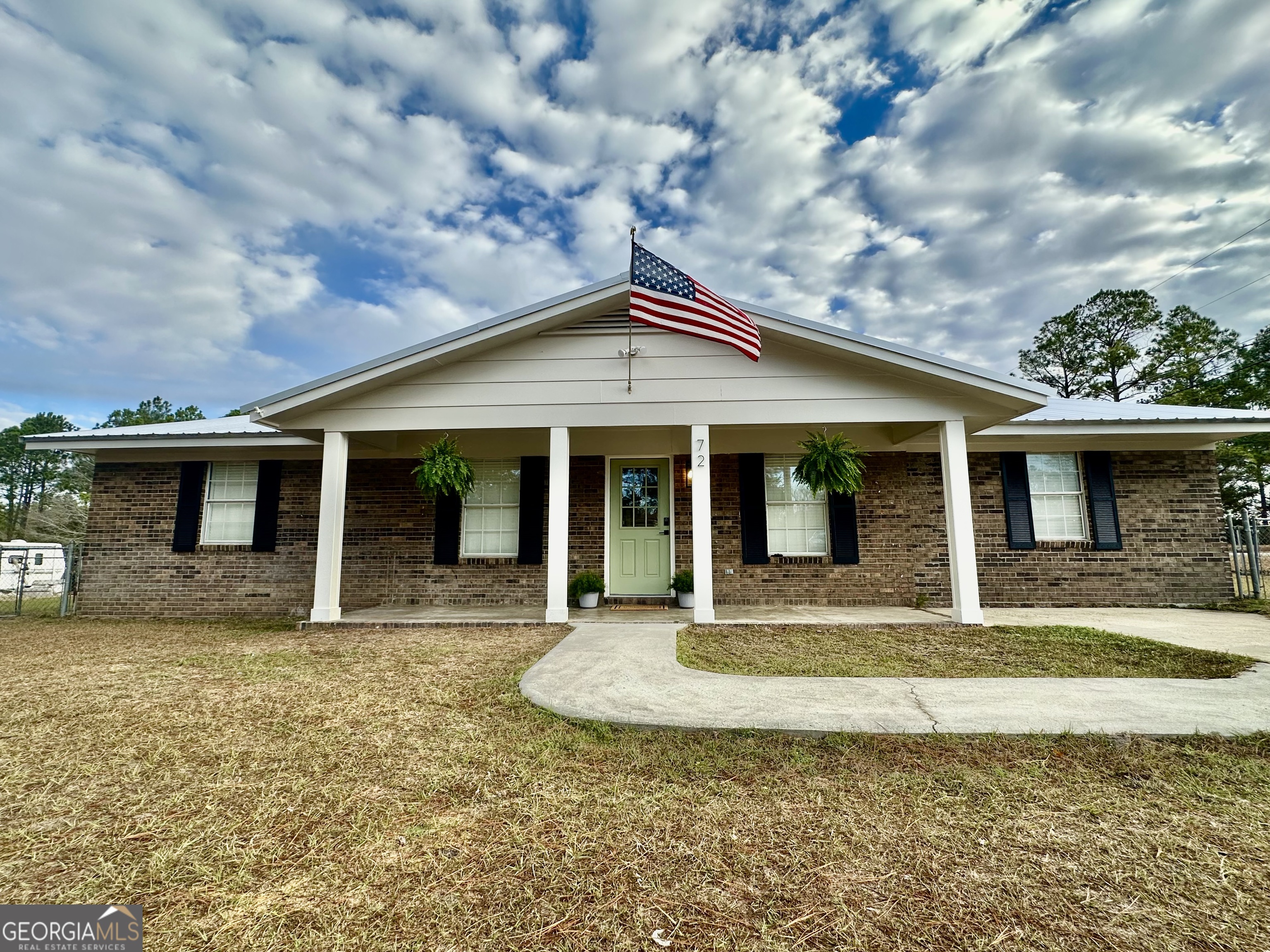 72 10th Street McRae-Helena, GA 31037 - Photo 2 of 26 a front view of a house with a yard chairs