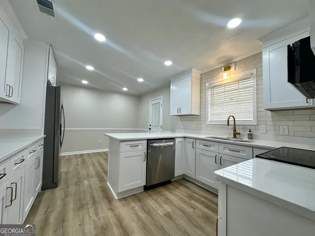 a kitchen with a sink microwave and cabinets