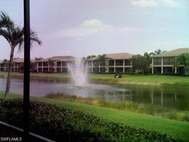 713 Regency Reserve Circle, Unit 5902 Naples, FL 34119 - Photo 1 of 9 a view of a house with a yard