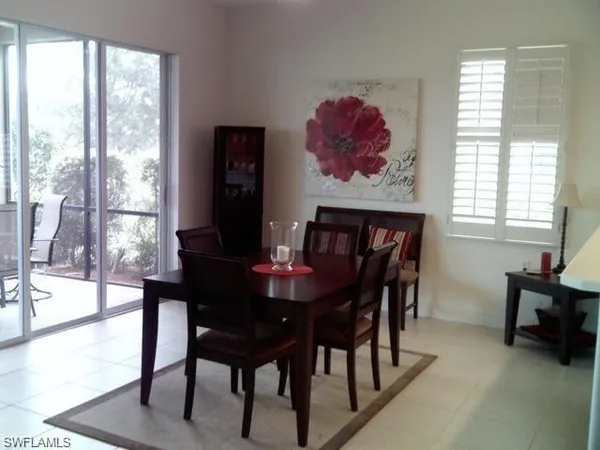 a dining room with furniture and window