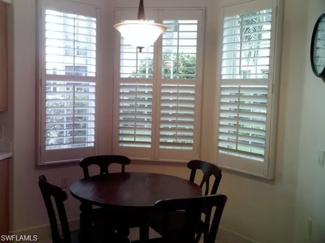 a view of a dining room with furniture and windows