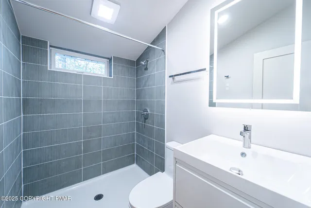 a bathroom with a sink toilet and shower