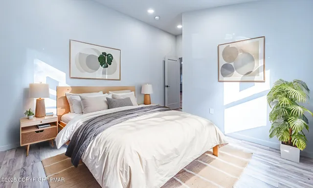 a bedroom with bed and painting on the wall